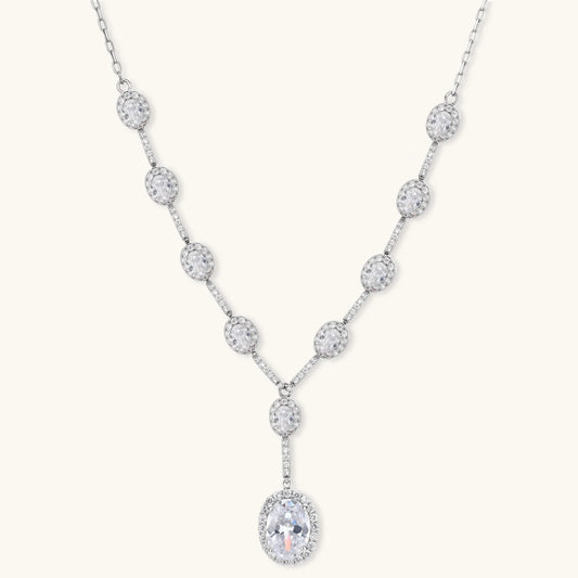 Elegant white gold plated jewelry set with oval cubic zirconia stones in halo settings, featuring Y-necklace and drop earrings.